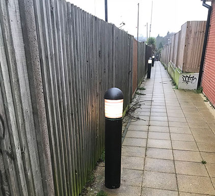 Illuminated LED bollard in alleyway