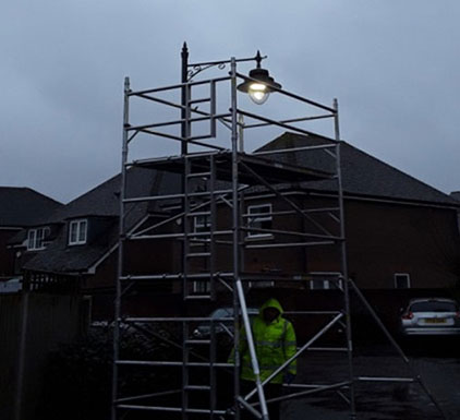 Scaffold tower access to street light lantern on outreach bracket